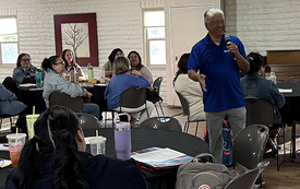 Speaker talking to room of attendees